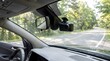 © Kirana - Black dash camera mounted on car windshield facing road