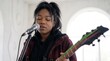 © Cosmic - Alternative young Black woman singing into microphone holding electric guitar with neon strings
