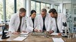 © Arafat - Geology research team studying mineral samples at table.