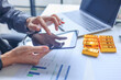 © Supitnan - Gold investor at office desk using tablet managing online account for buy or sell gold.
