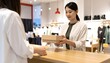 © EBG Stock Studio - Dos mujeres intercambiando una caja de cartón sobre un mostrador comercial