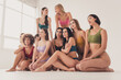 © deagreez - Group of diverse women in colorful underwear posing together, celebrating body positivity, confidence and natural beauty in a bright studio setting