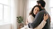 © Snake42 - Young couple embracing warmly indoors with eyes closed in a moment of deep connection and affection