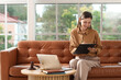© Pixel-Shot - Legal advice and consultation, female lawyer working on laptop with clipboard on sofa in modern office for remote legal services and justice system