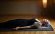© Bethany Birnie/Stocksy - Peaceful meditation in savasana yoga pose