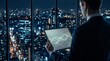 © Fang - Businessman standing by window looking at city skyline at night while holding tablet displaying digital data graphs, symbolizing corporate strategy analysis