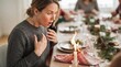 © Jafree - Woman reacts in shock as candle flames rise beside Christmas table linens during festive dinner. Holiday fire hazard, home safety and unexpected accident