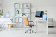 © Pixel-Shot - Remote work and corporate downsizing, empty office desk with computer and chair in modern workspace for business operations and professional environment