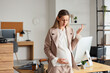 © Pixel-Shot - Workplace stress and pregnancy, pregnant businesswoman feeling overwhelmed and tired in modern office environment with deadline pressure and fatigue