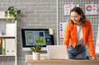 © Pixel-Shot - Web design and creative freelance work, woman working on laptop in modern office with digital interface on computer screen for user experience project