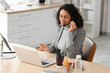 © Pixel-Shot - Customer support and remote work, smiling woman with headset talking on video call using laptop in modern office for business communication and service
