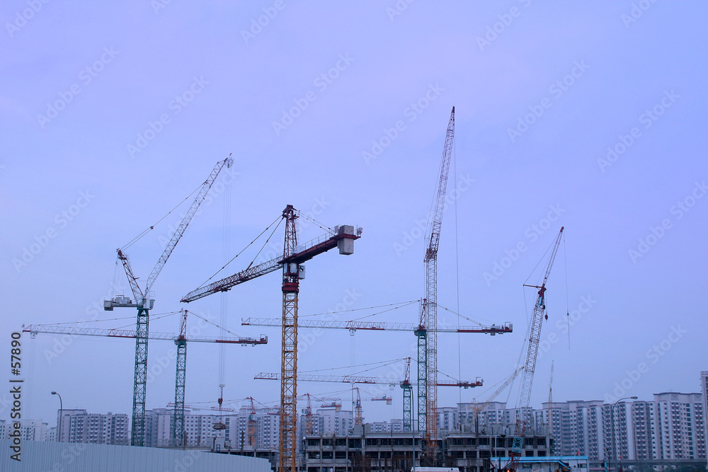 construction cranes at twilight construction cranes at twilight