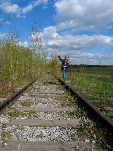 girl  balancing on rail