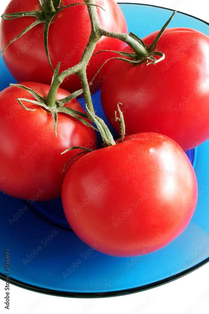 Fotografie tomatoes on blue glass plate