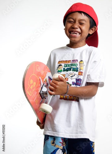happy boy holding his skateboard