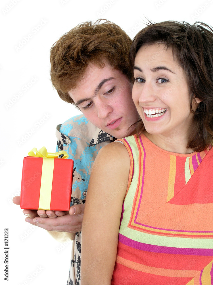 young man offering present to girlfriend young man offering present to girlfriend
