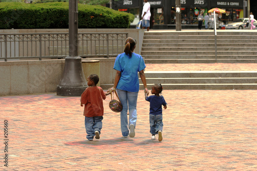 mother and two childeren walking holding hands