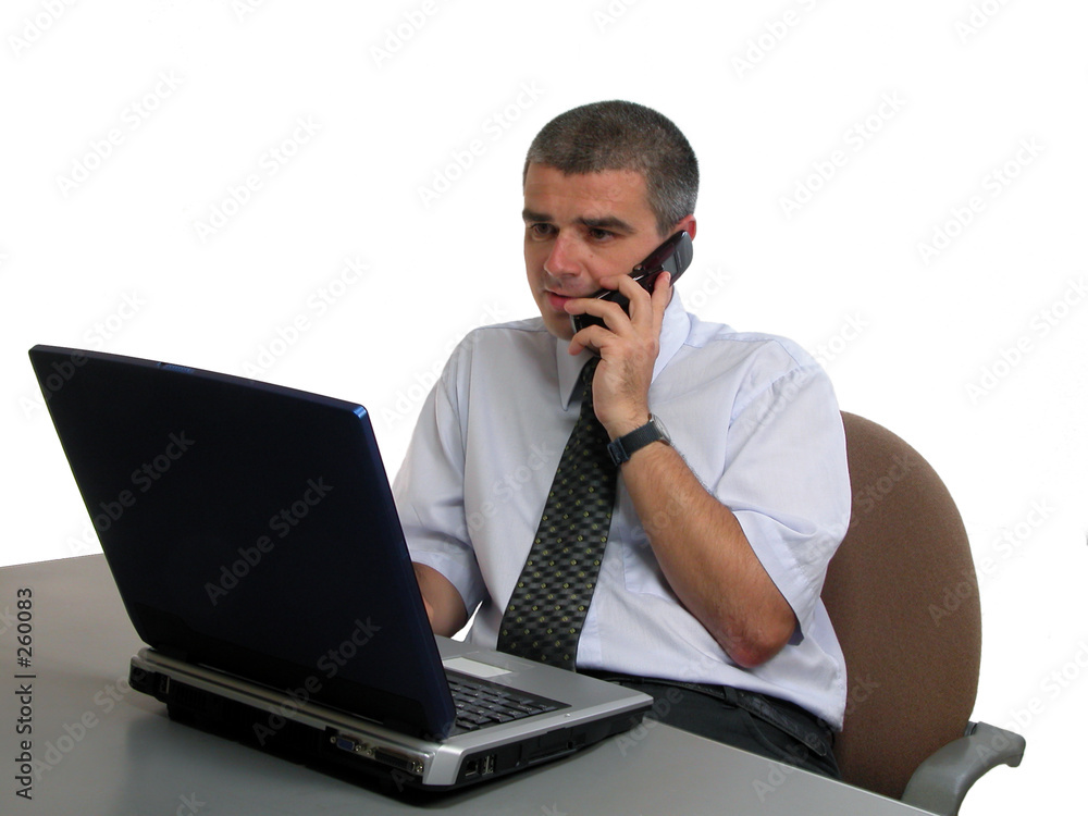 man speaking to the phone at the office desk man speaking to the phone at the office desk