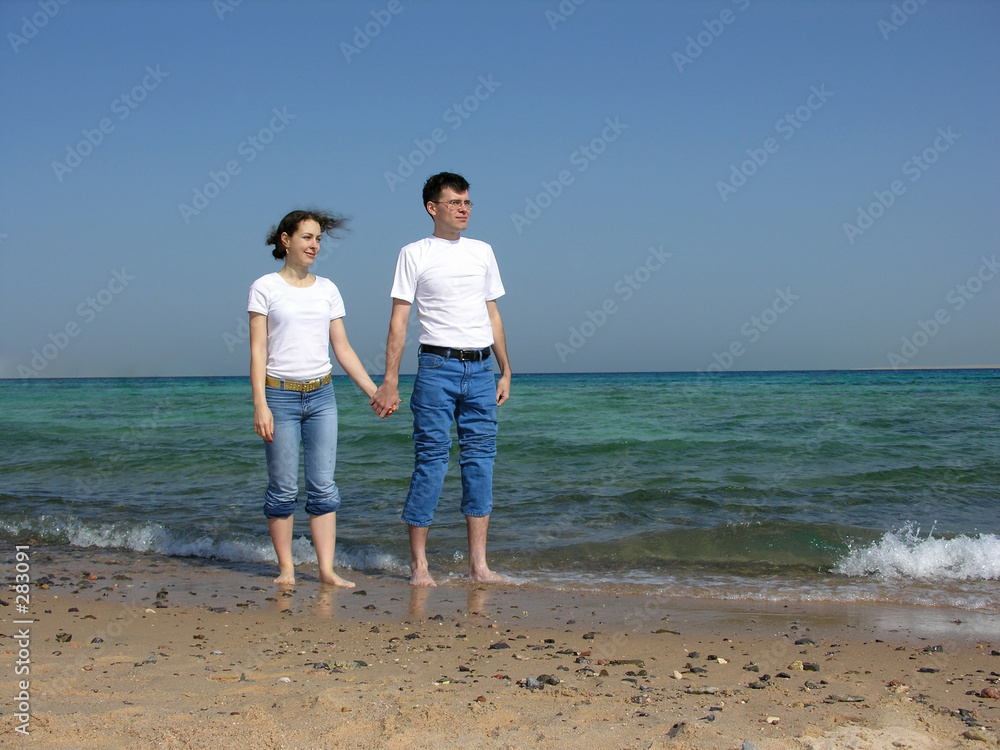 couple stand. faces. sea. sunny day couple stand. faces. sea. sunny day