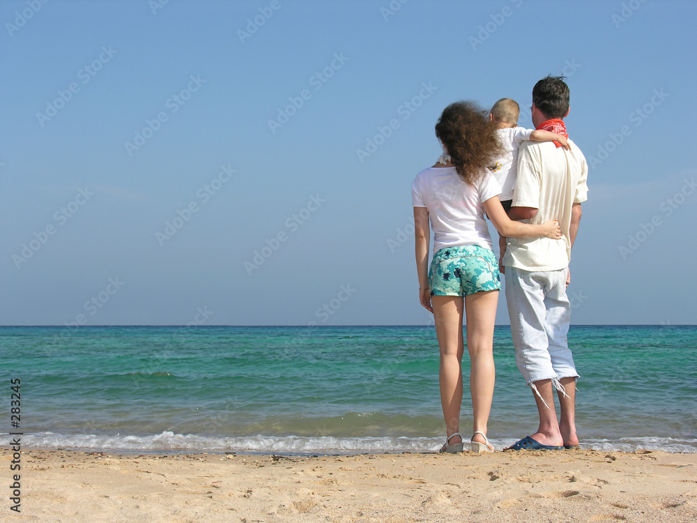 back family of thre on beach