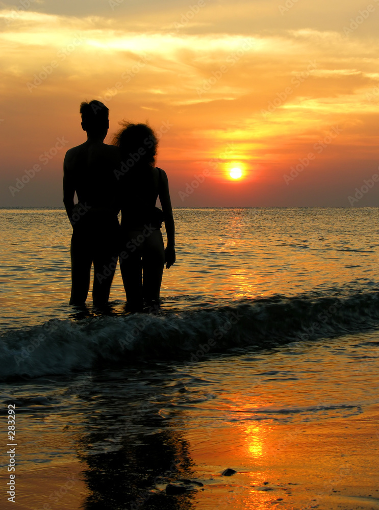 couple on beach. sunrise.