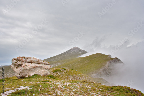 mountain peak surrounded by fog photo