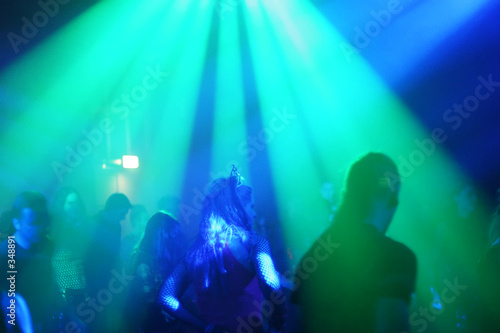 young female dancer in/between beams of light