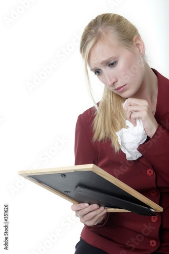 Fotografija woman holding picture frame crying