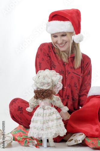 cute girl with doll for christmas photo