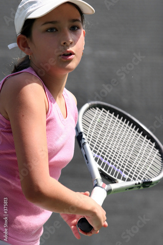 young girl playing tennis