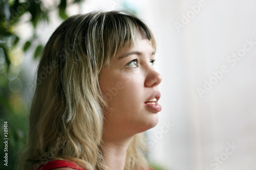 profile of a blond girl looking up
