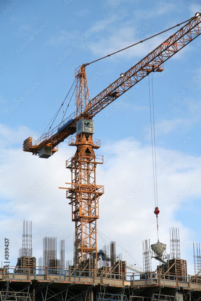 a construction site with a yellow crane