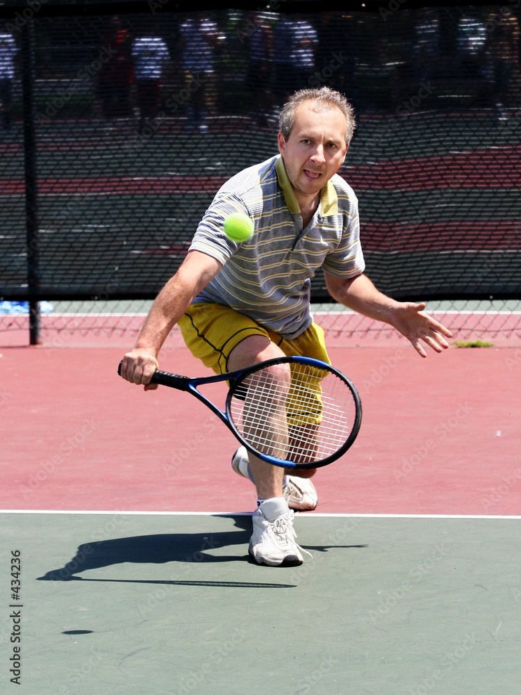 middleage man playing tennis