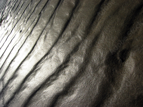 cascade of sunlight across ripples in the sand