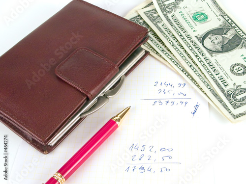 us dollars, notebook and pen