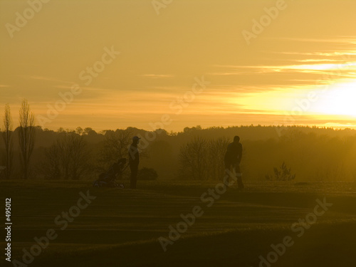 golfers at sunset