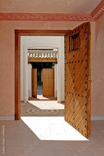 open front door of a villa in spain looking into the into the ga