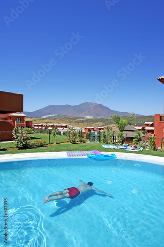 man swimming underwater in pool