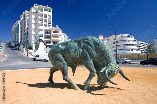 cast iron spanish bull in center of roundabout photo