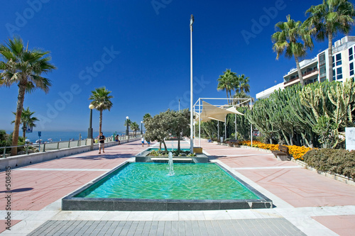 sandy beach promenade and water fountains at estepona in souther photo