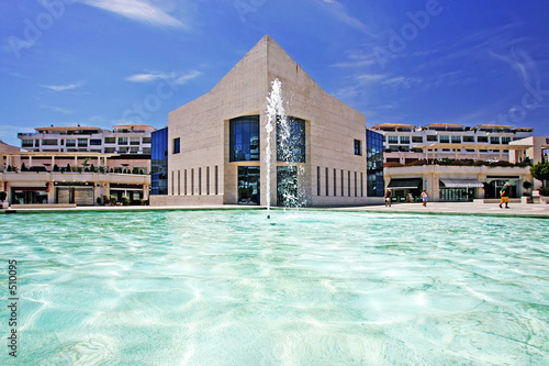 amazing architecture of modern building next to pond with founta