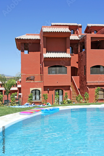 swimming pool and apartment block on spanish vacation urbanisati photo