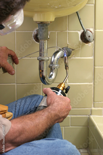 plumber using welding torch