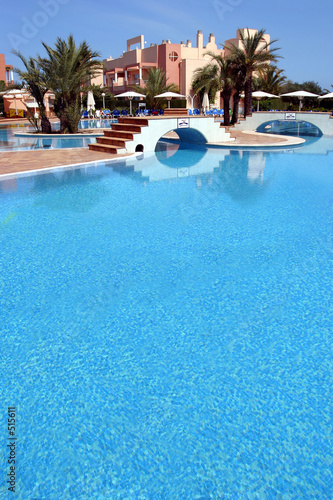 large, blue swimming pool in luxurious spanish complex