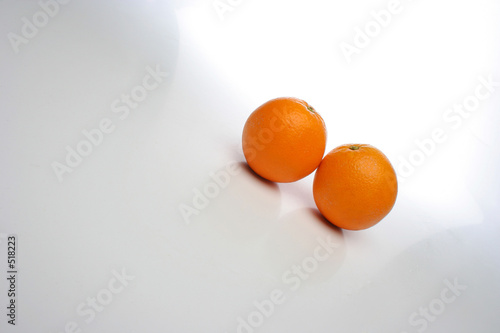 a pair of juicy oranges