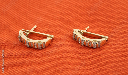 jewelery 010 gold earing with diamond red background