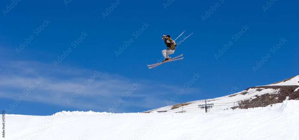 man skiing on slopes of ski resort in spain