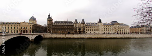 france, paris: seine river, la conciergerie in winter
