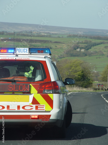 police car and slow sign