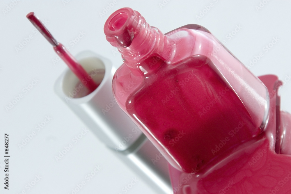 nail polish spilling on a mirror with the brush standing at an a nail polish spilling on a mirror with the brush standing at an a